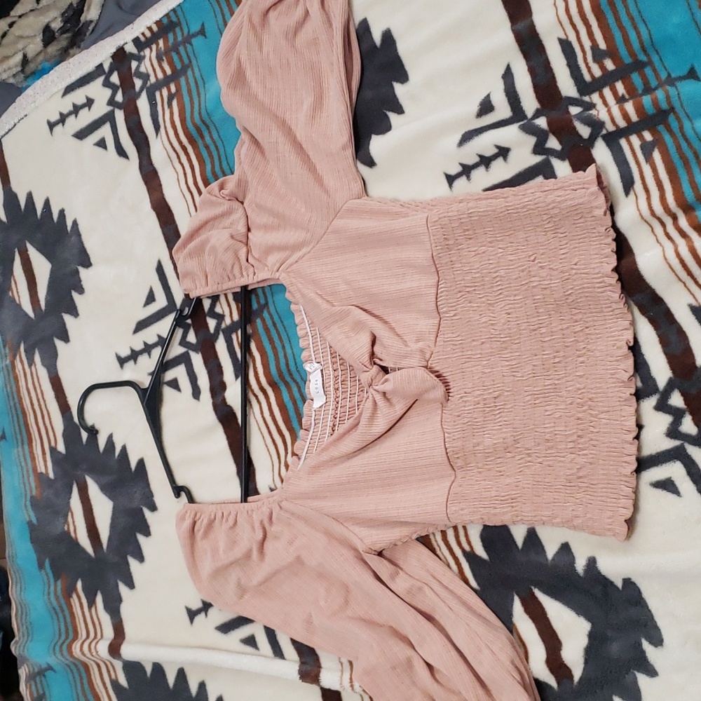 Cute dressy shirt. Its a pretty tan color. I've never worn it, bought new.